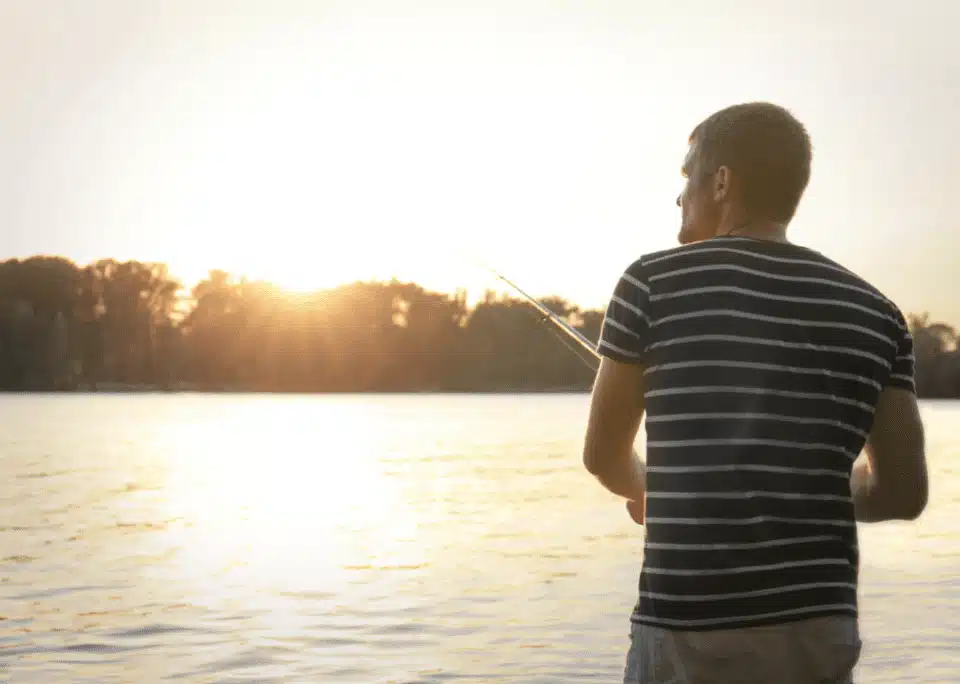 man fishing on lake