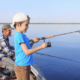 father and son fishing on lake